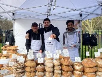 Social enterprise Breadwinners selling bread at a market stand