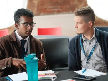 Two people in conversation at a table