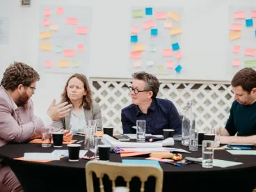 A group of people at a table having a discussion