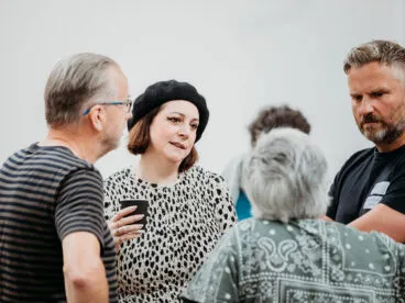 A group of people in a circle having a discussion