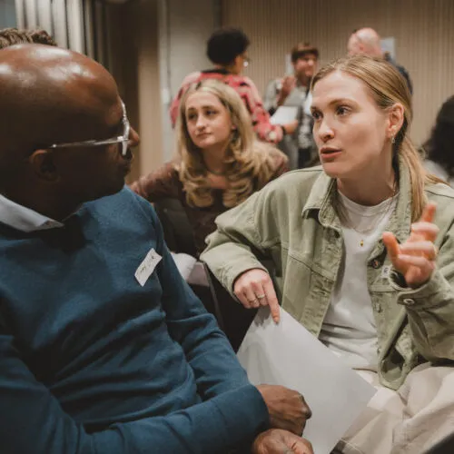 Two people deep in discussion during an in person event