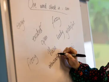 A person writing on a flip chart